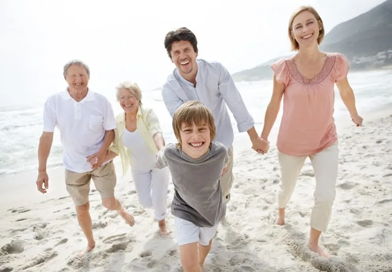 Happy family walking on the beach - Outdoor