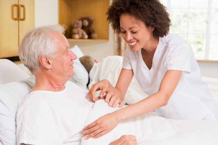 Nurse Helping Senior Man © Depositphotos