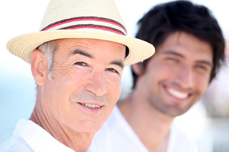 Father and son enjoying each other's company on a sunny summer's © Depositphotos