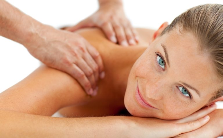 Smiling woman enjoying a massage © Depositphotos