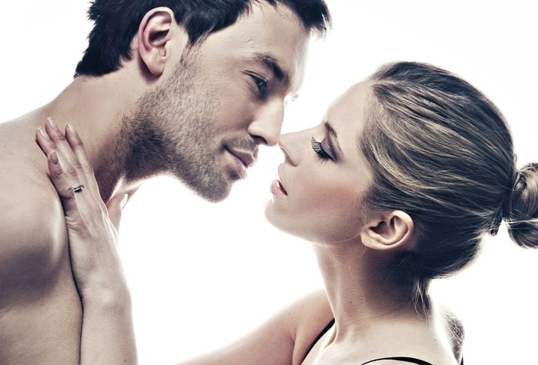 Portrait of handsome couple gently kissing | Stock Photo © 