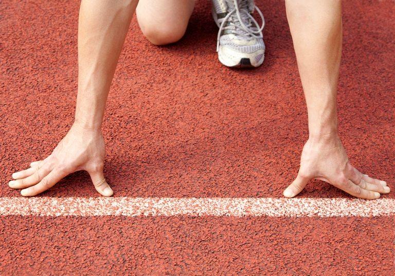 Athlete at the start line of the stadium | Stock Photo © Depositphotos