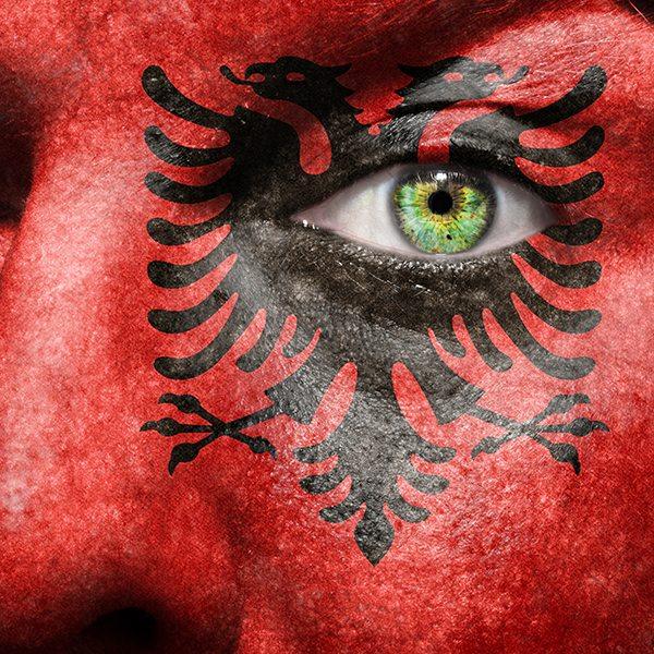 Flag painted on face with green eye to show Albania support