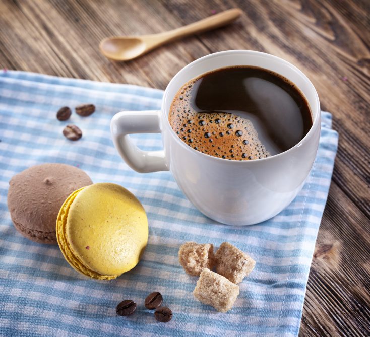 Cup of coffee and french macaron.