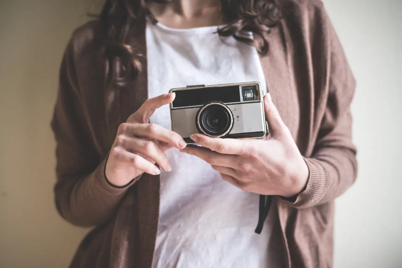 close up of hands woman with old camera