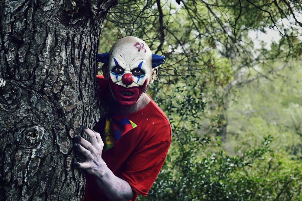 scary evil clown in the woods