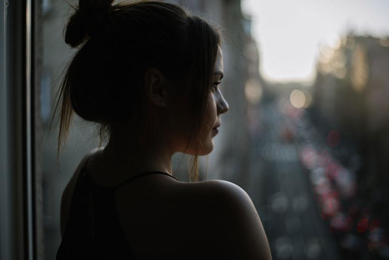 Mihajlo Ckovric stock photography woman standing by a window