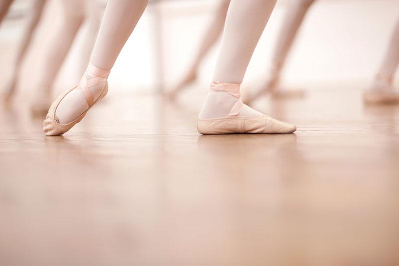 Detail of ballerinas legs in dance class, low section