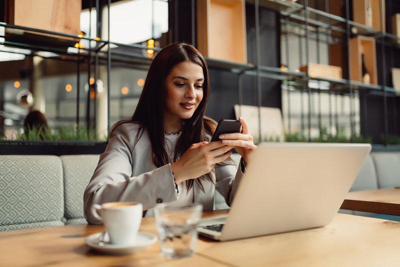 Nebojsa Tatomirov stock photography - Woman at the cafeteria using mobile phone