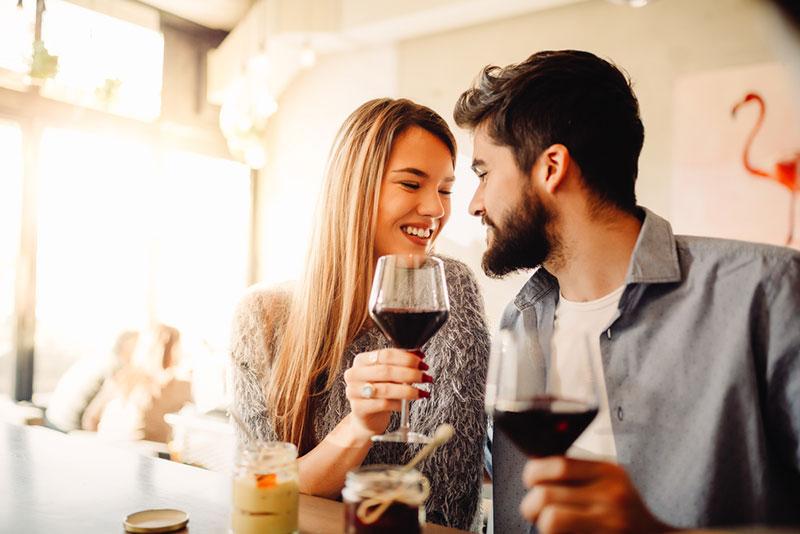 Nebojsa Tatomirov stock photography - Young couple celebrating their anniversary in cafe with glasses of wine