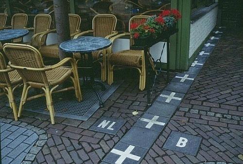 This is the border between Belguim and the Netherlands. This picture is taken in Belguim outside a cafe located in the Netherlands