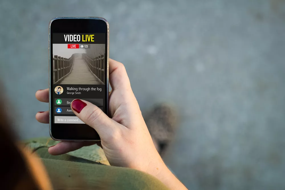 Woman walking and watching a live video