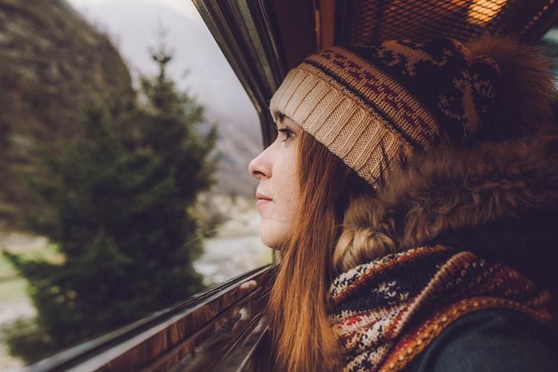 Young woman looking out the window