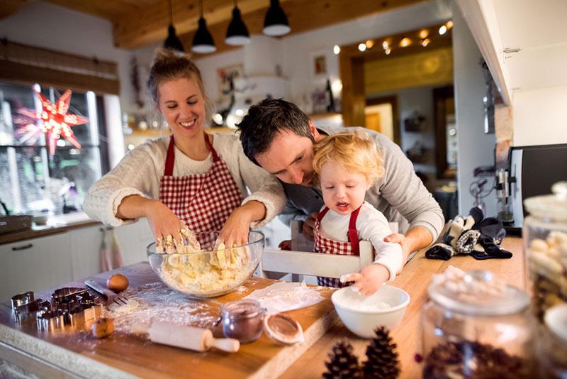 Young family making cookies at home.