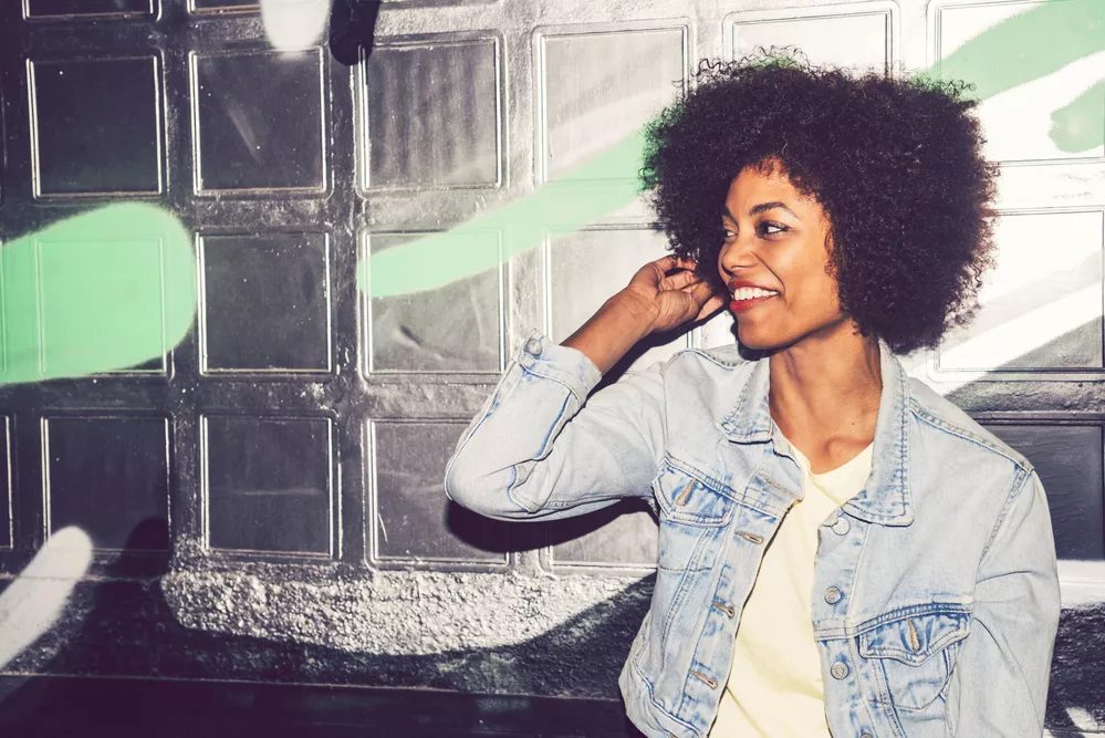 Portrait of a young black woman, model of fashion in urban backg