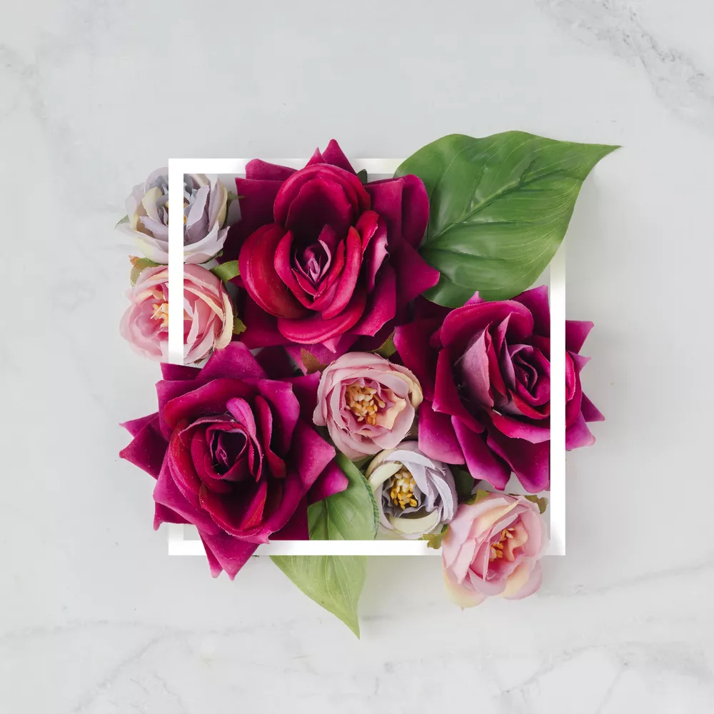 Creative layout made with flowers and white frame. Spring minima