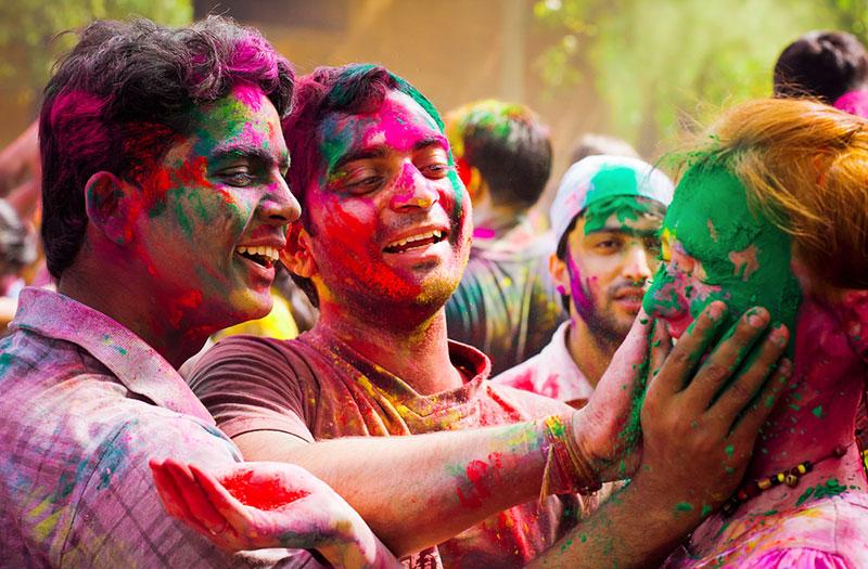 People are smearing powders at holi festival of colors