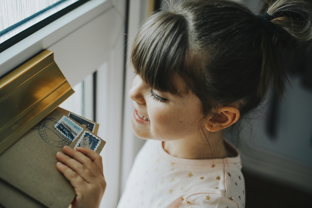 Little girl picking up the mail