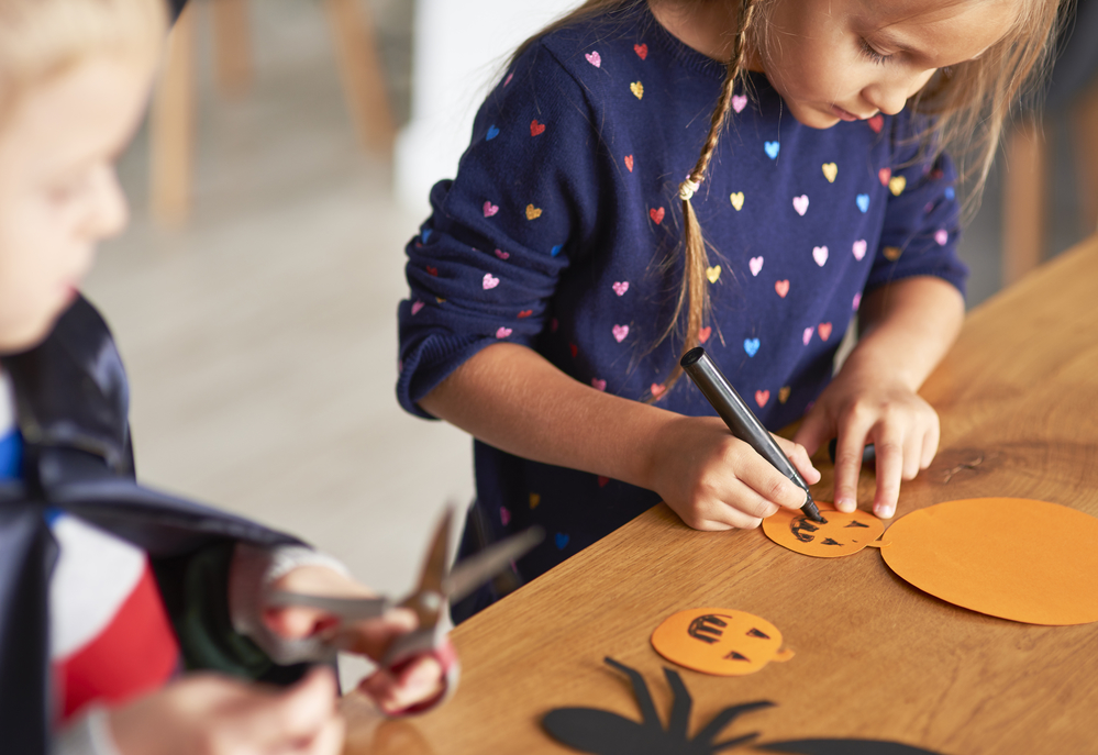 Cute girl preparing halloween decorations