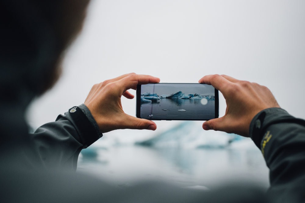 Traveler or tourist makes photos of icebergs