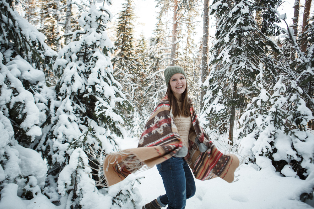 Beautiful woman among snowy tree