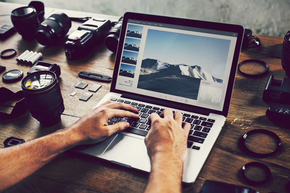 Photographer editing photos on a laptop