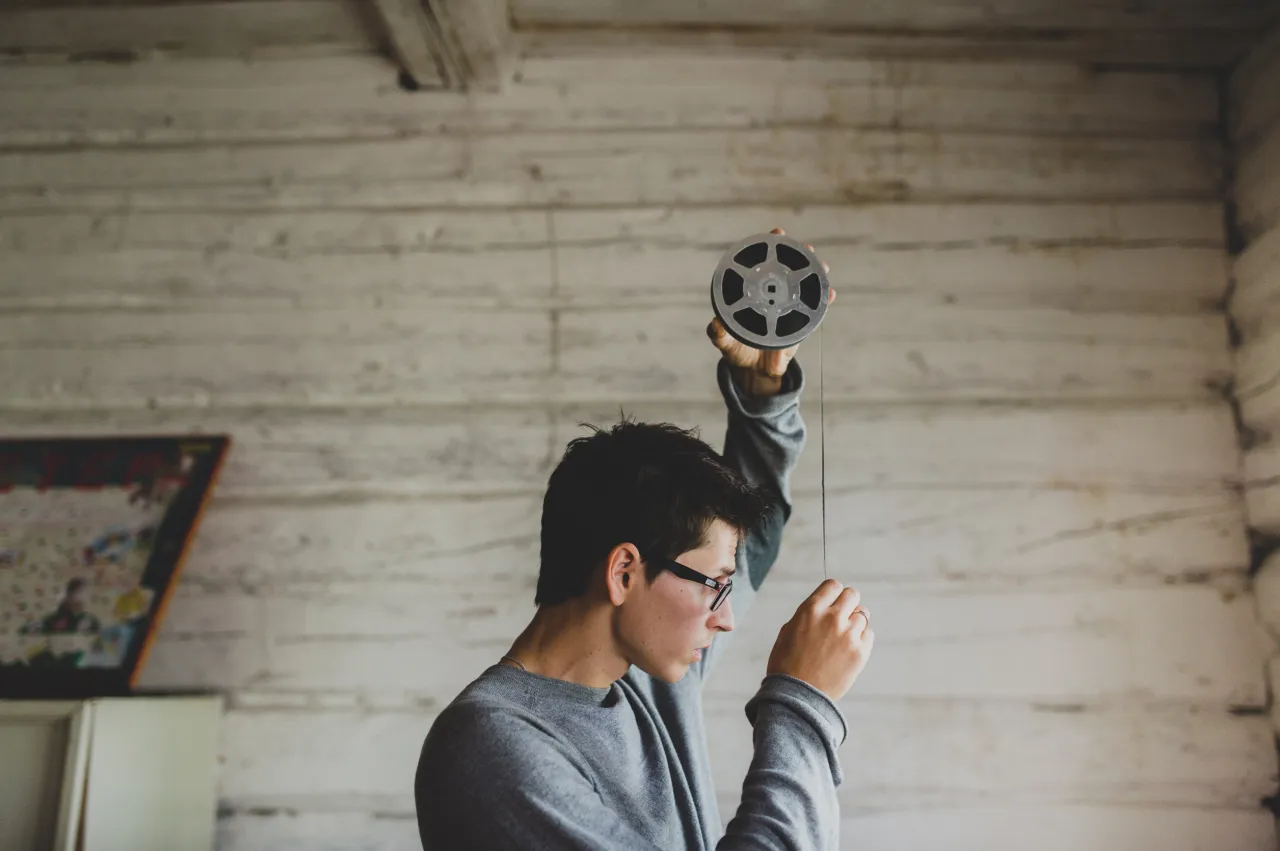 Man looks at an old video tape