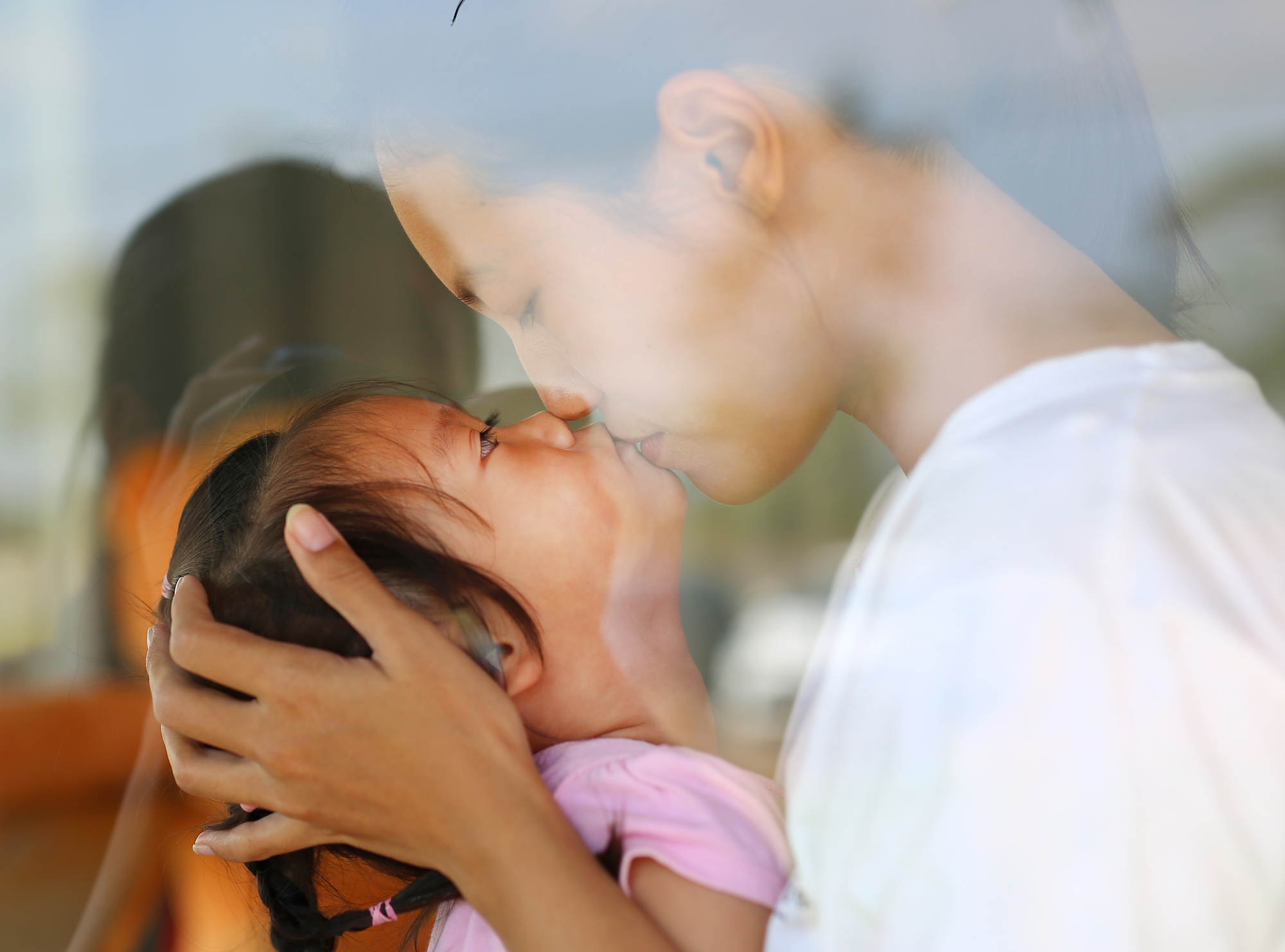 stock photo mother kissing daughter