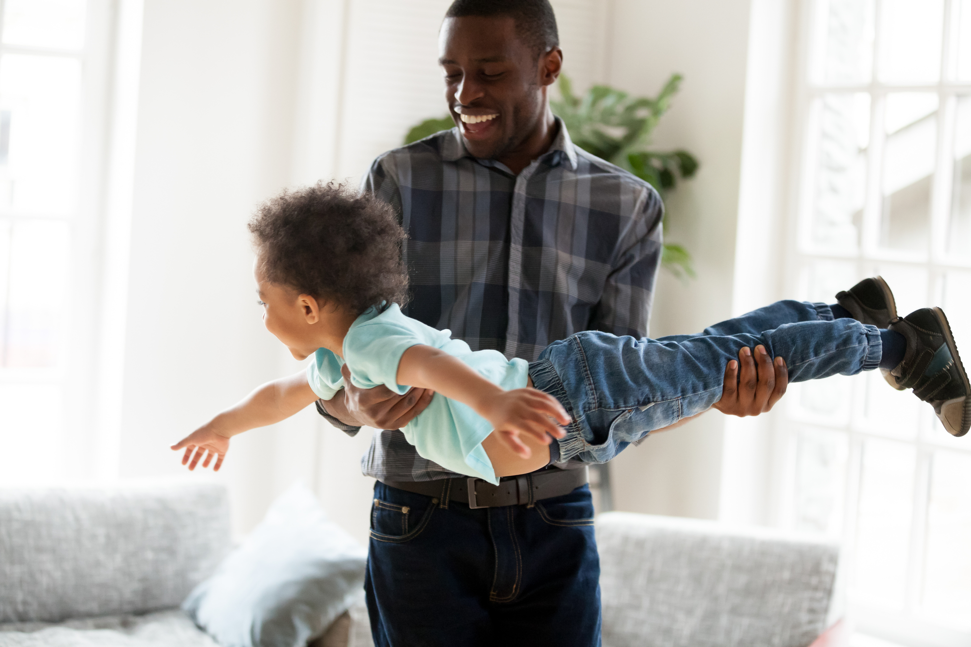 father playing with child stock image