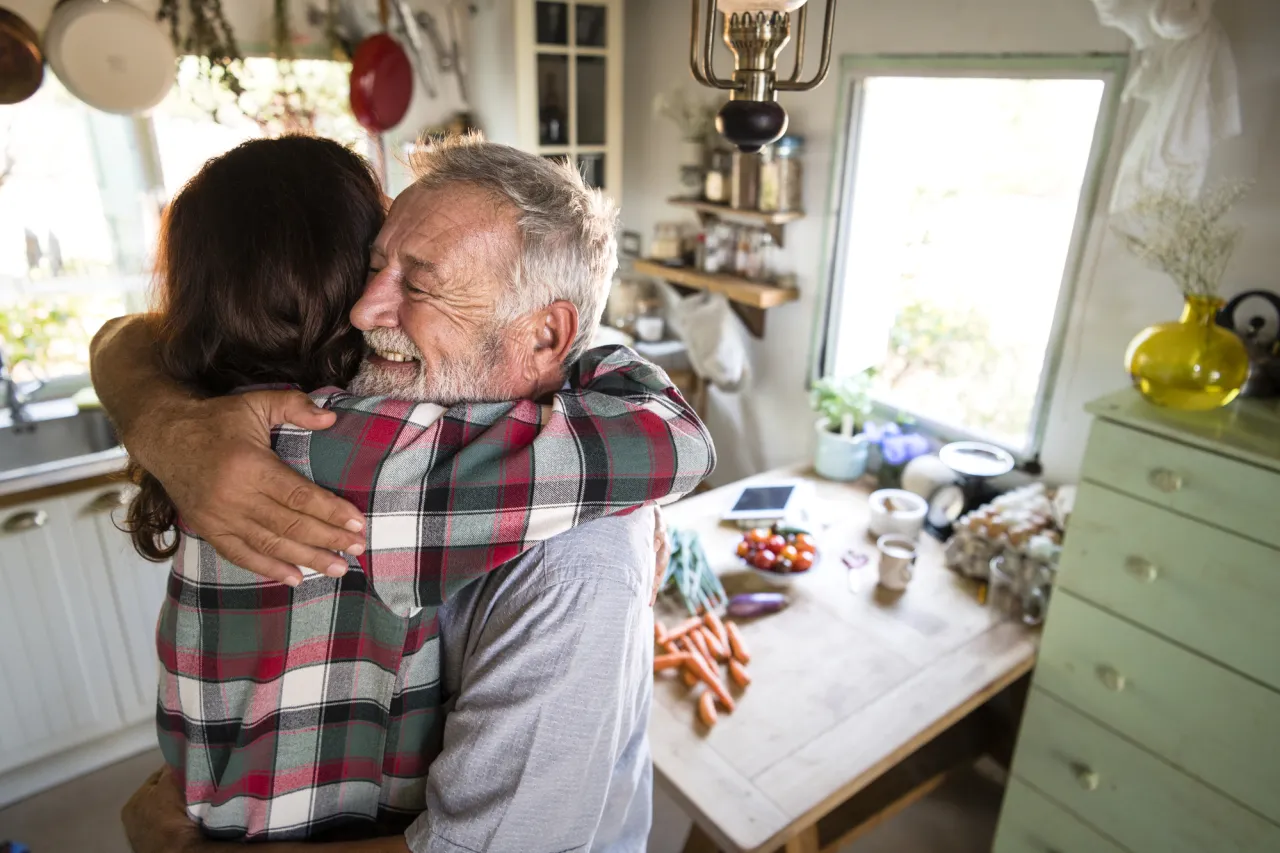 Father welcoming daughter in the kitchen stock photo