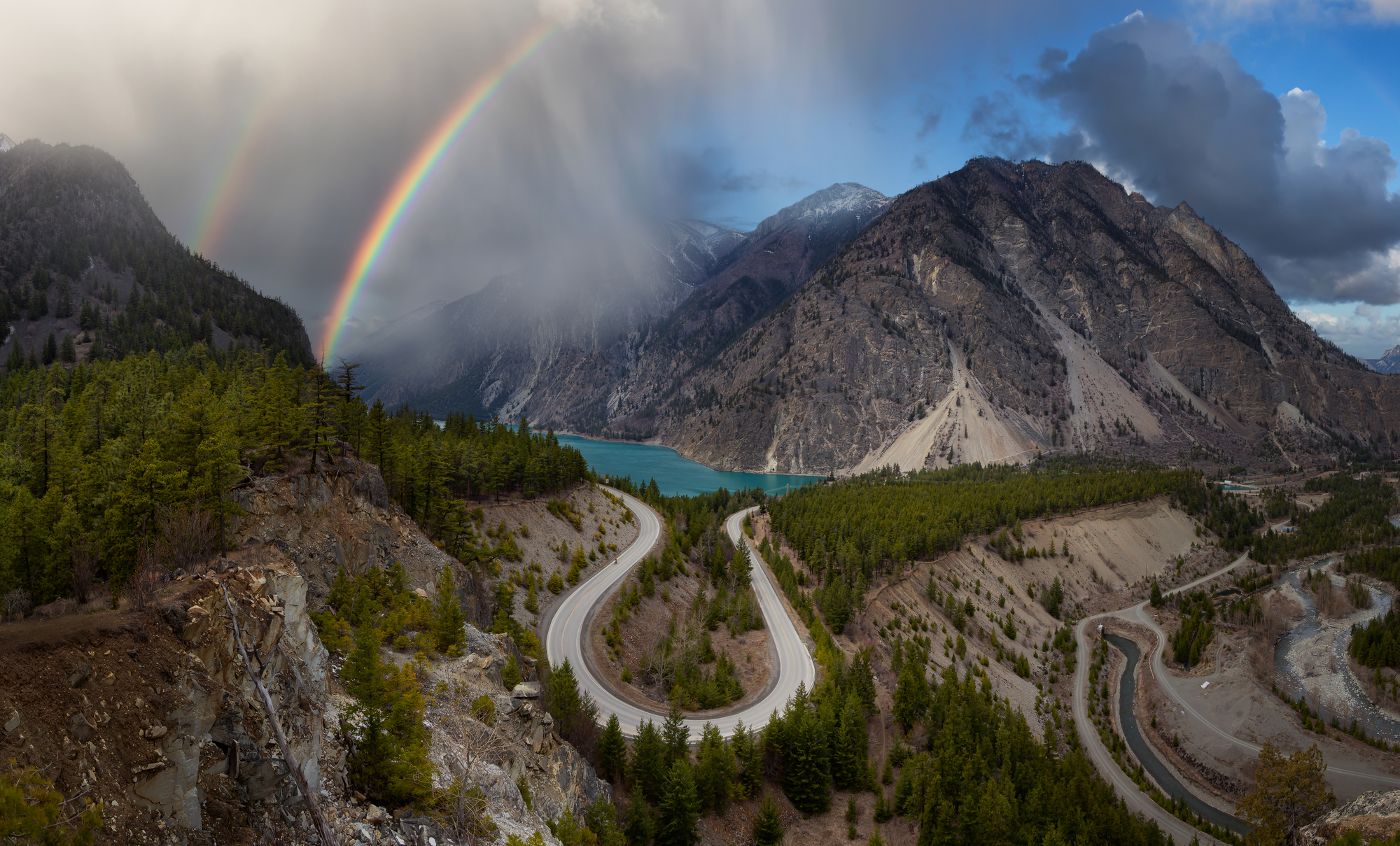 drone photo of mountains and rainbow