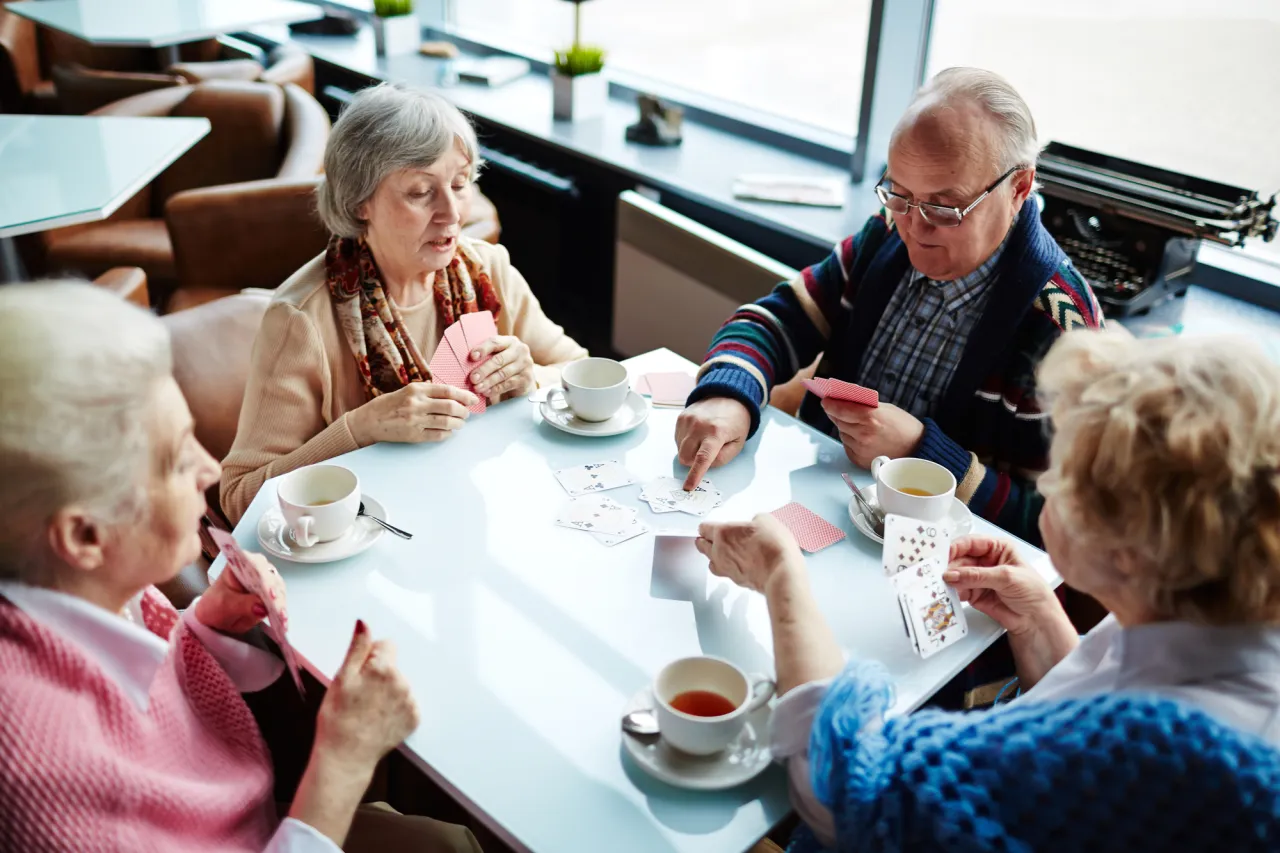 happy seniors playing cars stock photo