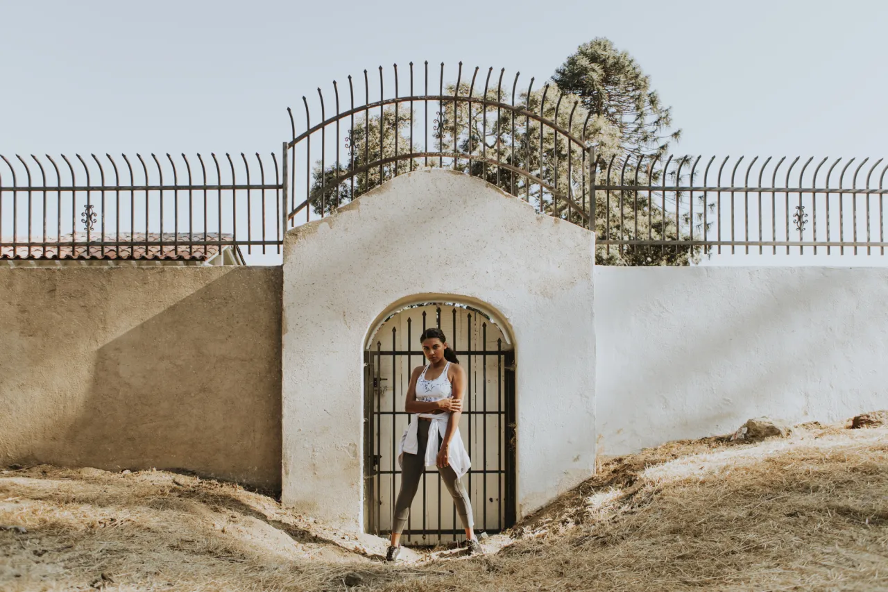 Fit woman standing by a gate