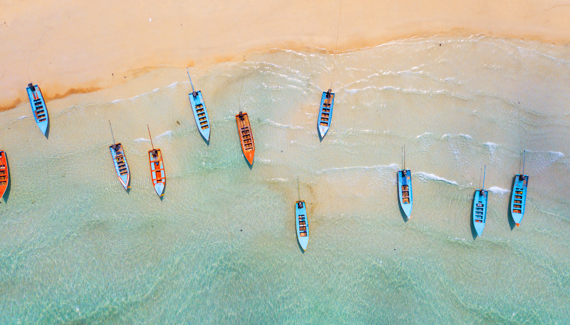 Aerial: Shoreline with fishing boats