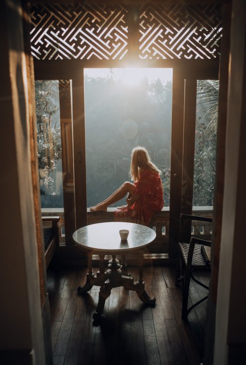 stock image of girl sitting on a balcony