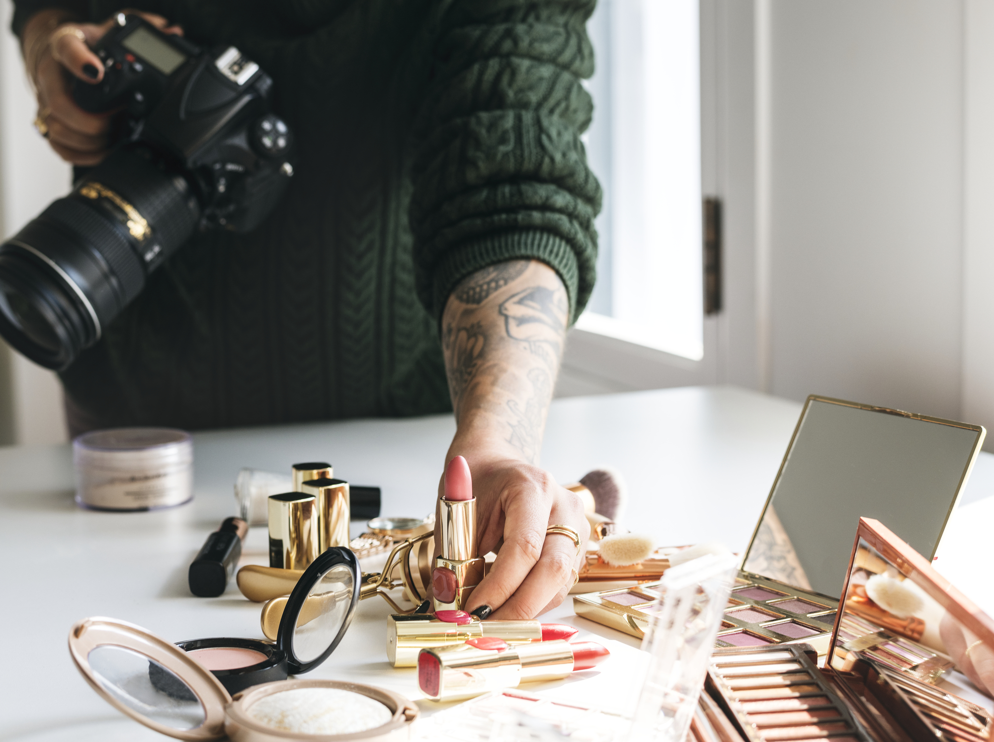 Beauty blogger taking photo of cosmetics stock image