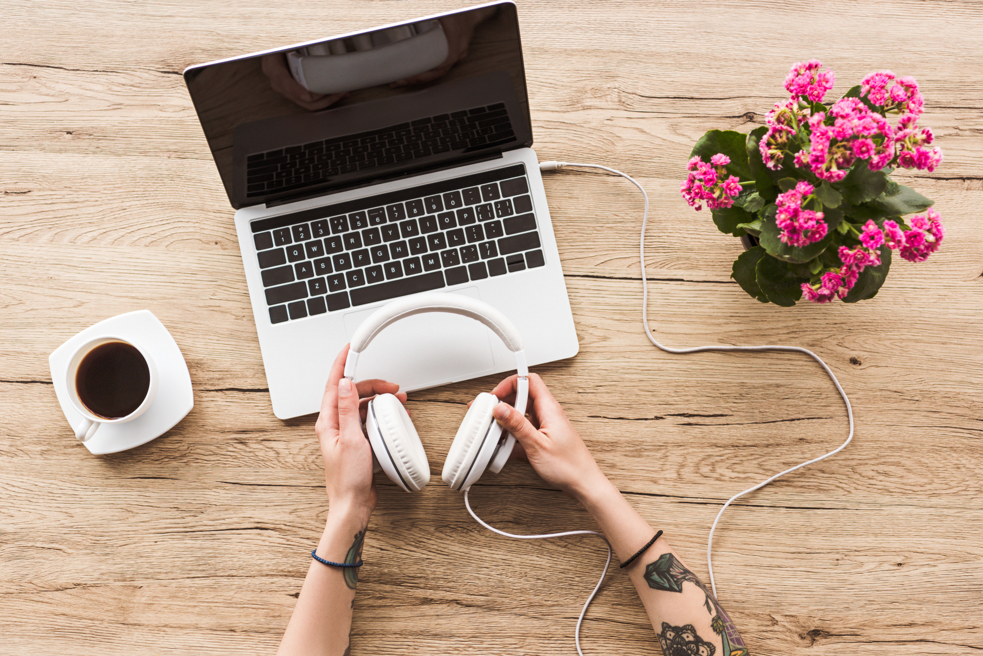 top view stock image hands with laoptop and headphones