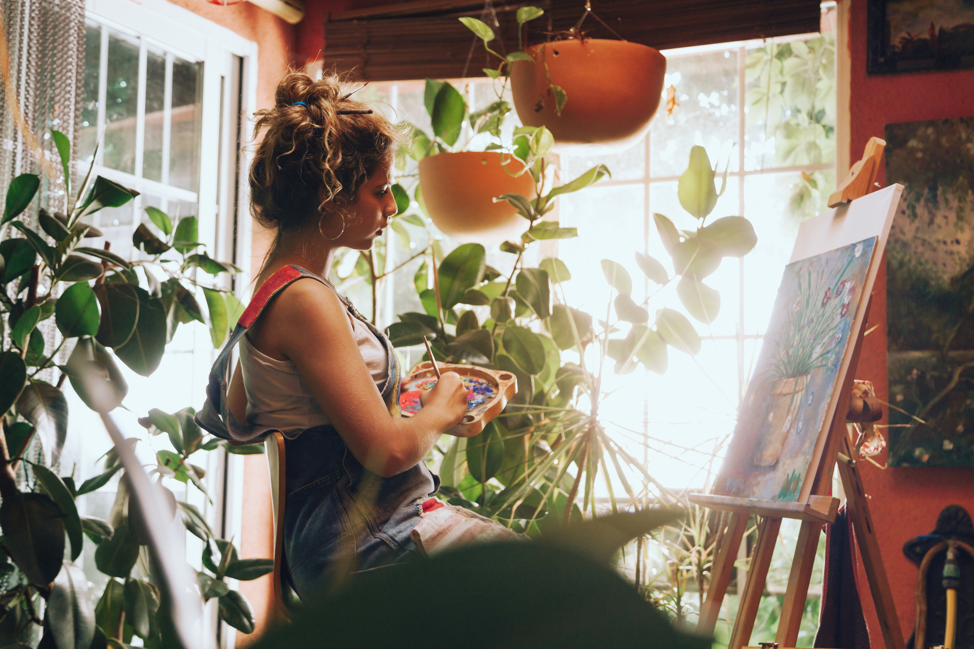 Indoor shot of professional female artist painting