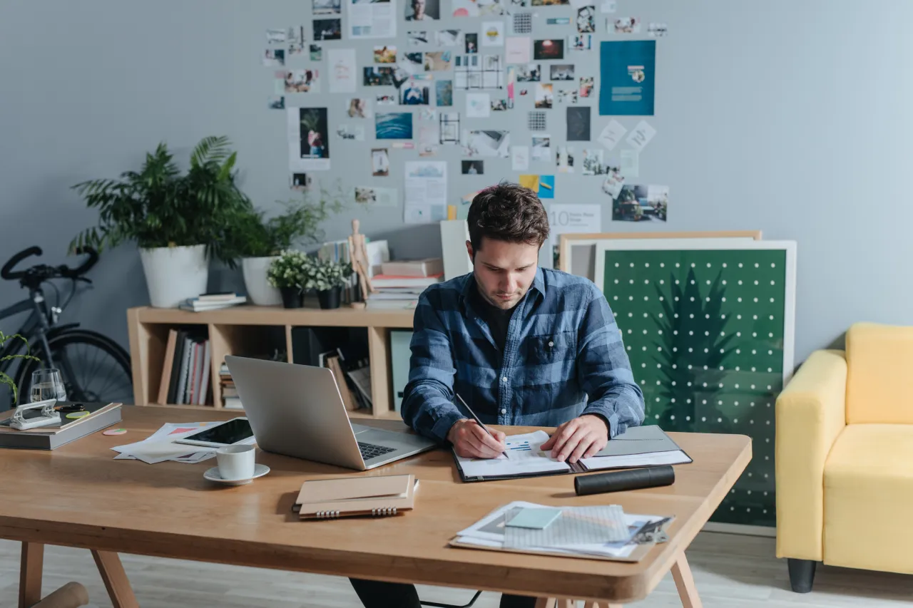 casual businessman writing at his office stock photo