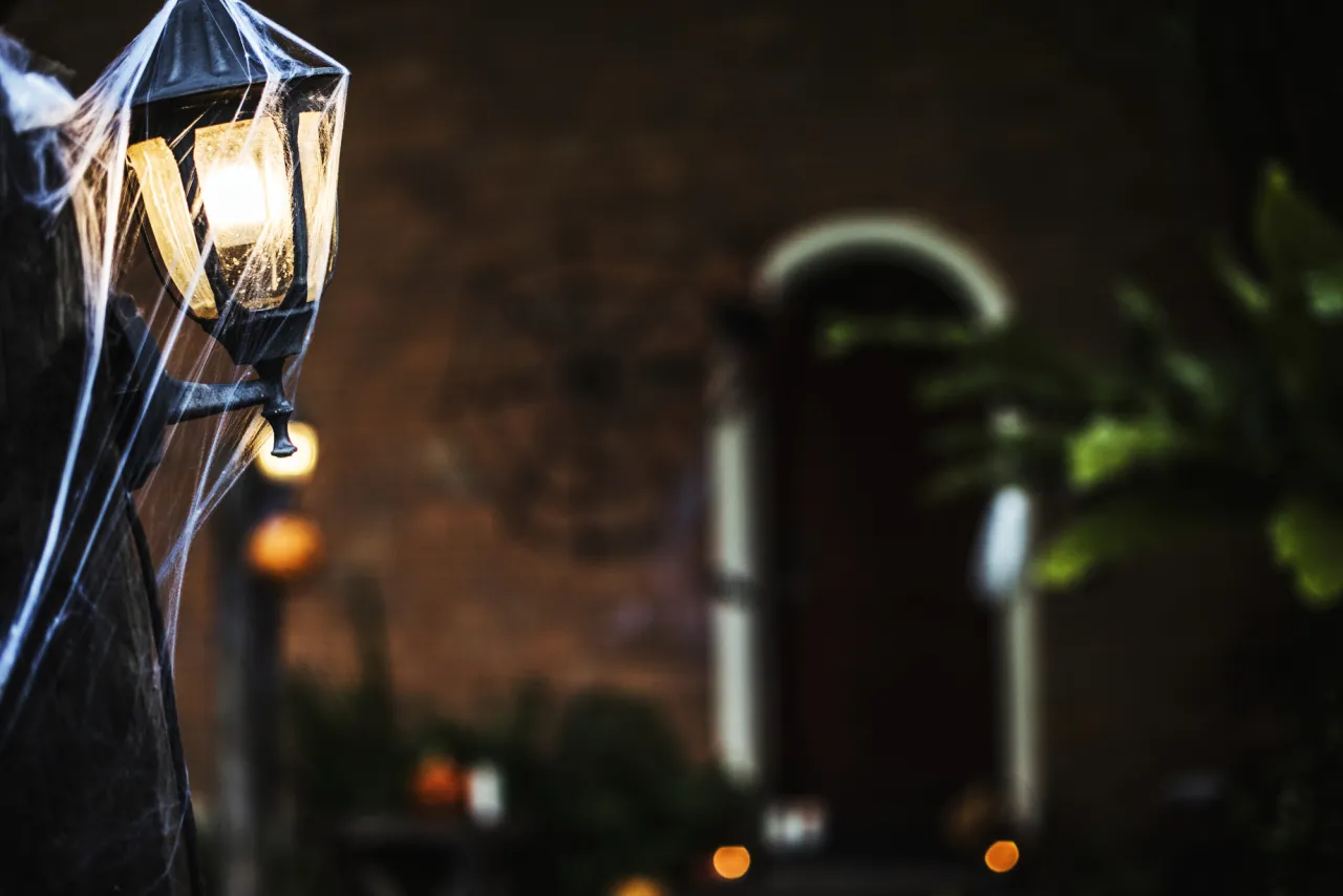 stock photo Light post with spiderweb on Halloween