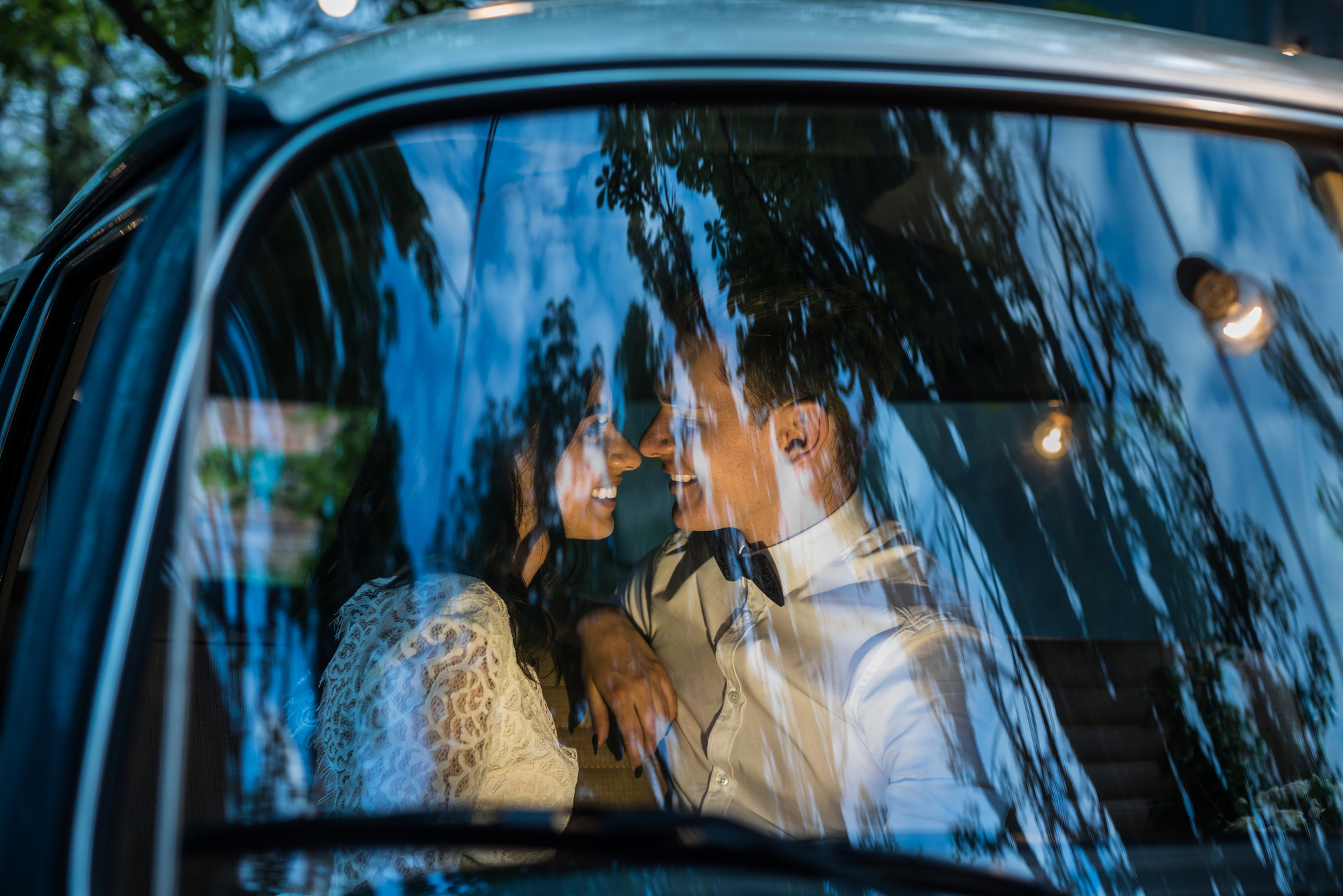 Cheerful happy young couple sit in the retro-minibus stock photo