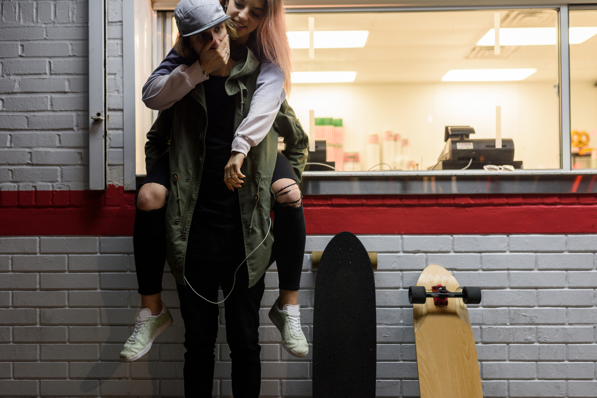 Young hipster girl on the back of her boyfriend stock photo