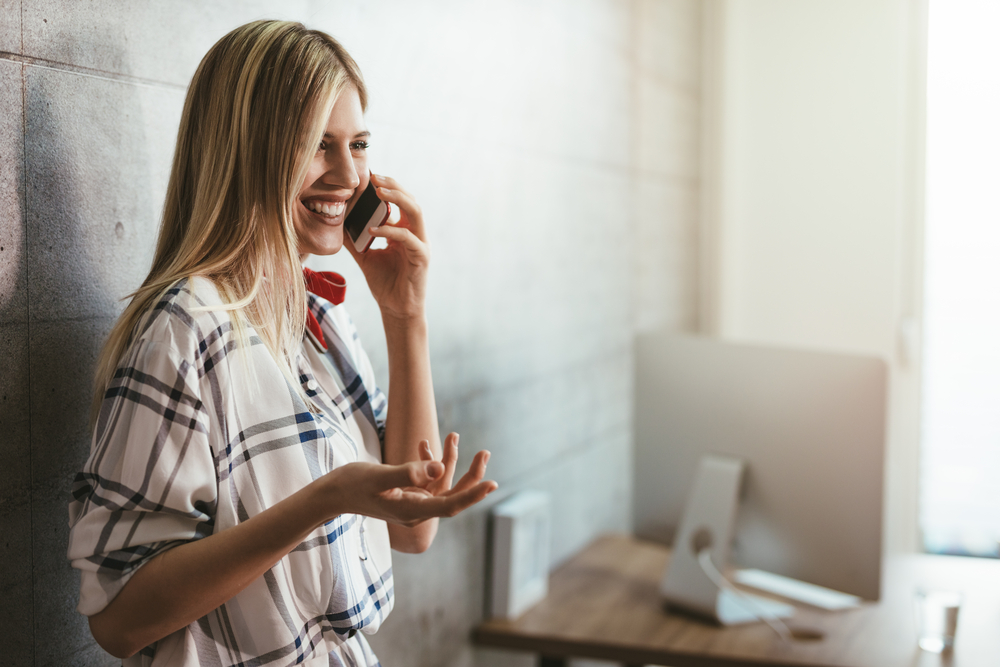 stock photo girl with a cellphone at her office