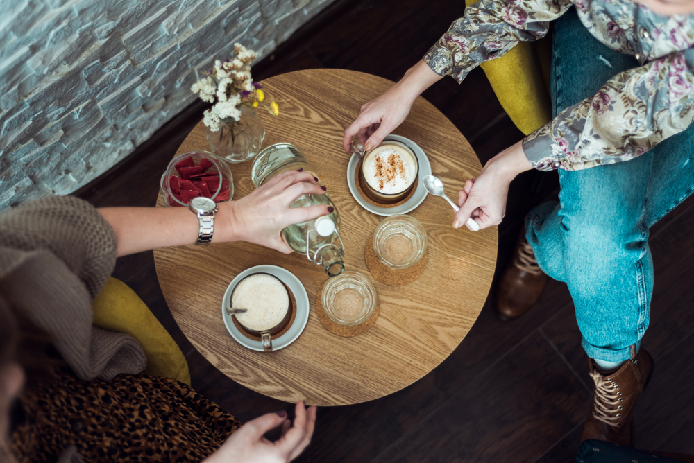 stock photo flat lay two girls drinking coffee