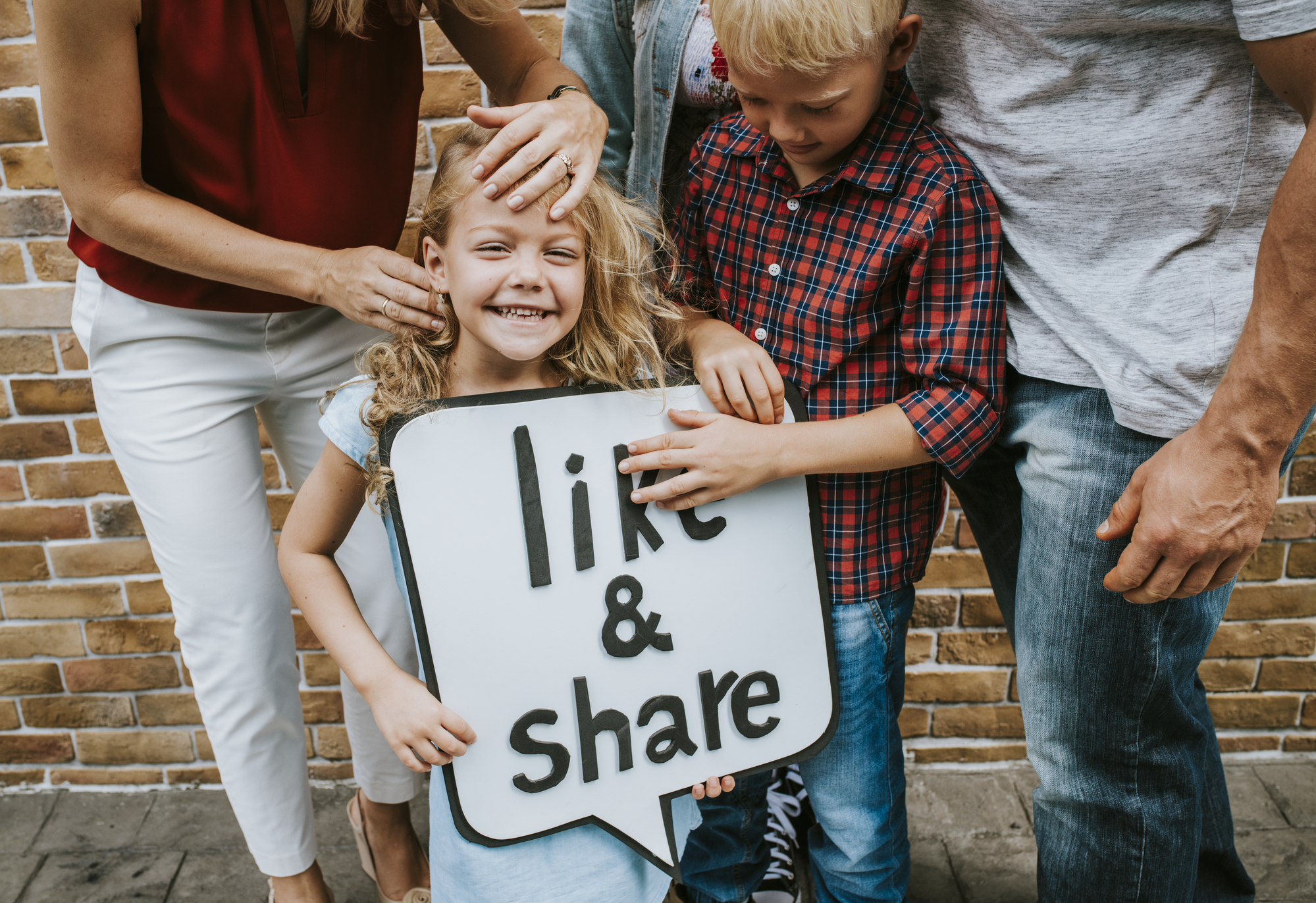 Children smiling holding a sign stock photo