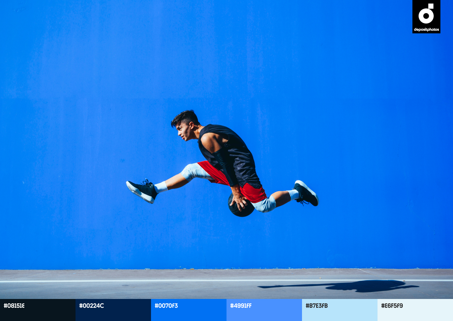 stock photo young man holding a basket ball jumping