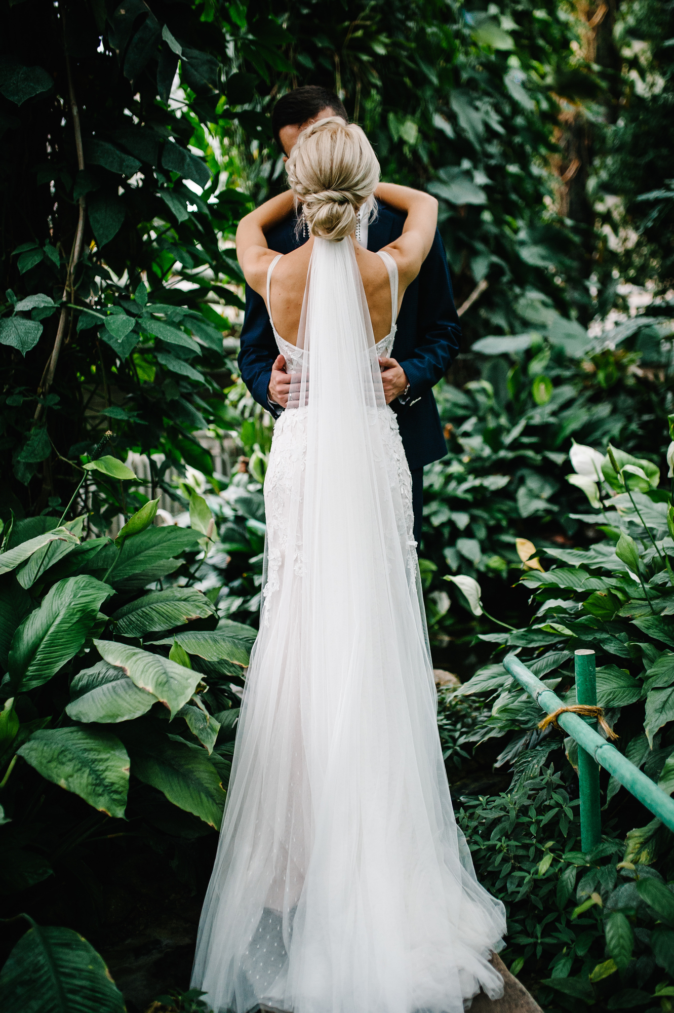 Newlyweds are standing back and kissing - portrait idea to try