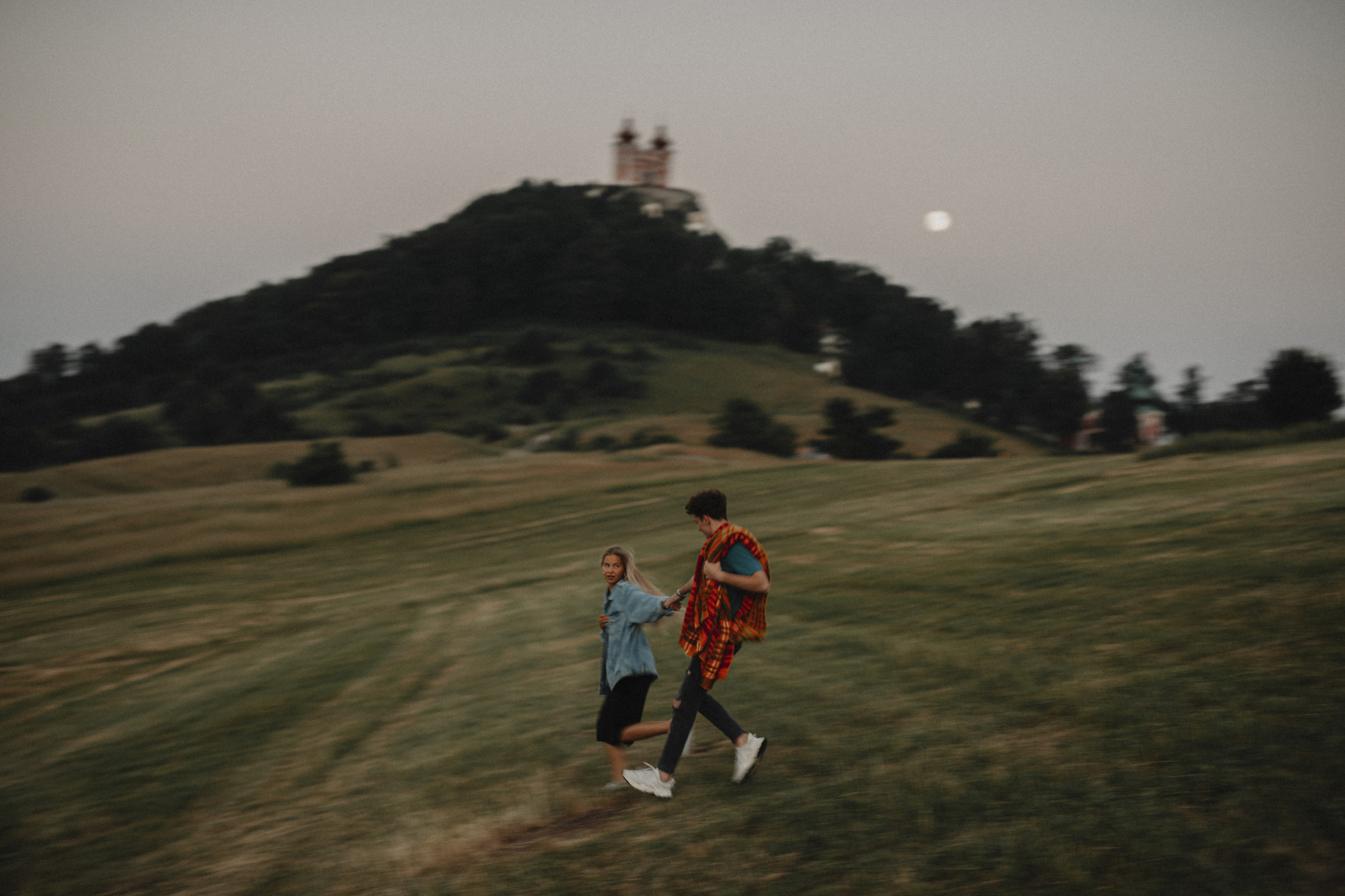 Young couple walking in nature at sunset - portrait photography ideas