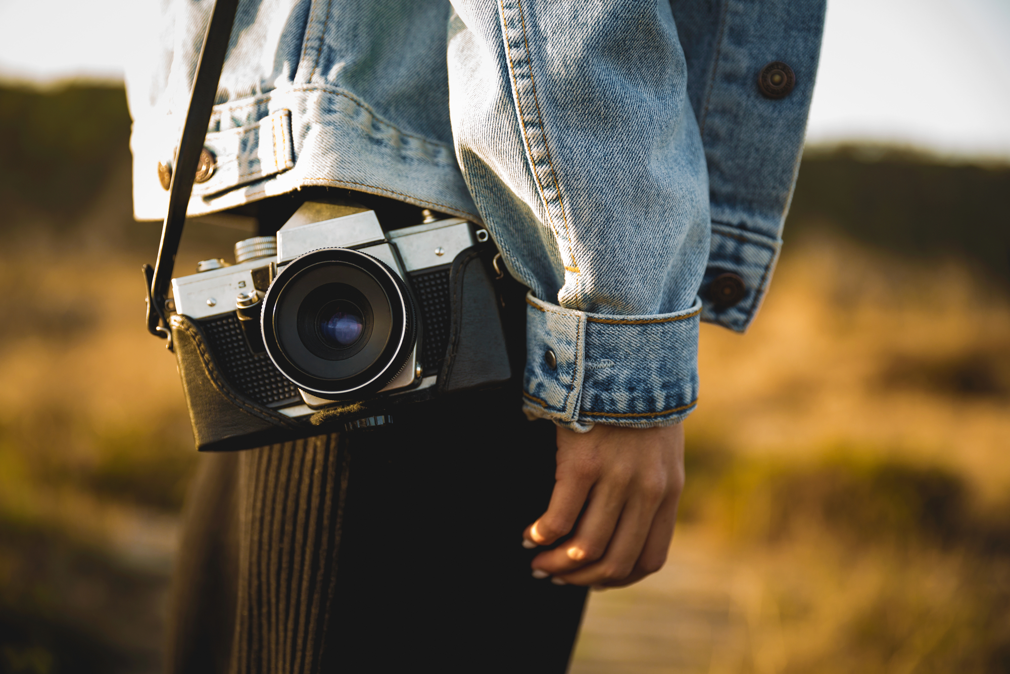 Closeup of woman with analog camera outdoors