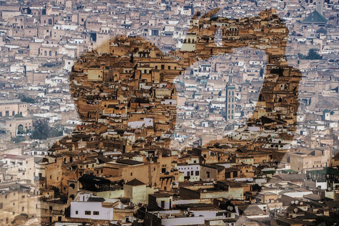 Silhouette of a mobile photographer who photographs the old town (medina) of Fes in Morocco.